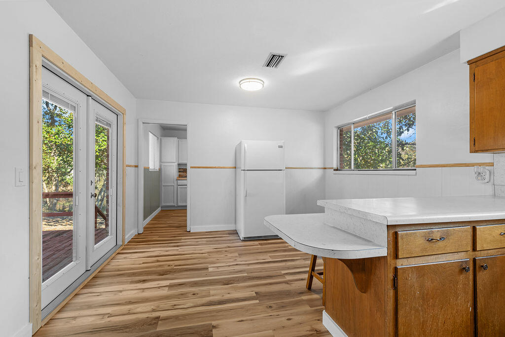 1623 18th Street Niceville, FL 32578 - Photo 13 of 41 a hallway with a table chairs and wooden floor