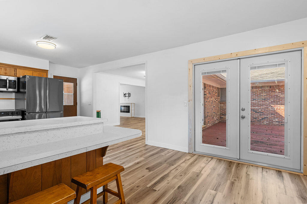 1623 18th Street Niceville, FL 32578 - Photo 14 of 41 a view of a hallway with wooden floor and livingroom