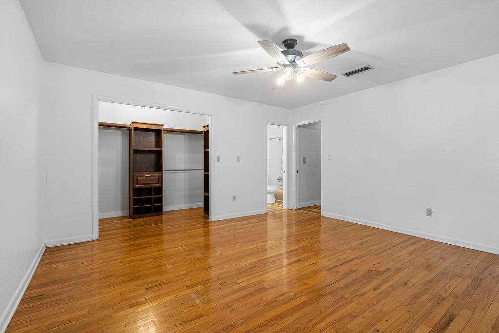 1623 18th Street Niceville, FL 32578 - Photo 18 of 41 a view of an empty room with wooden floor