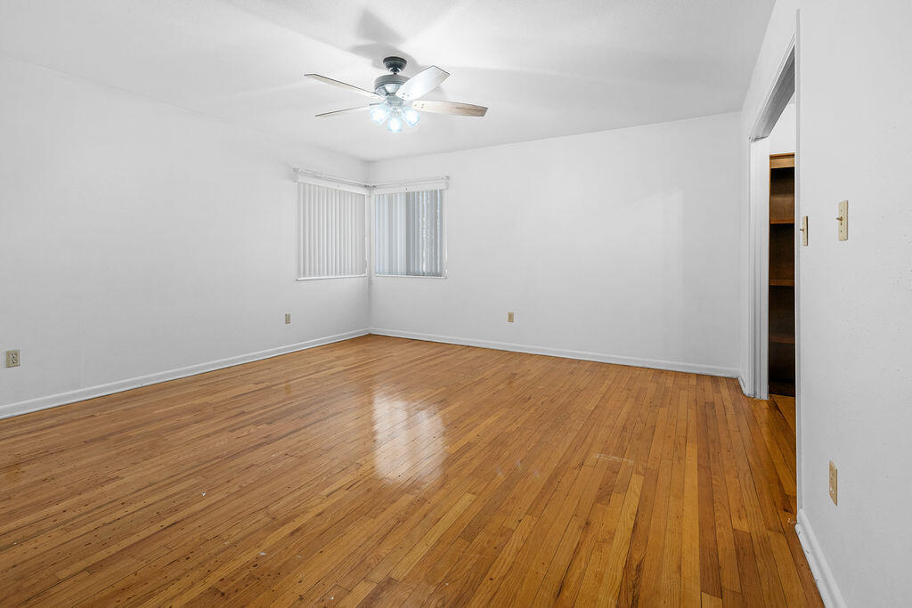 1623 18th Street Niceville, FL 32578 - Photo 19 of 41 a view of an empty room with wooden floor