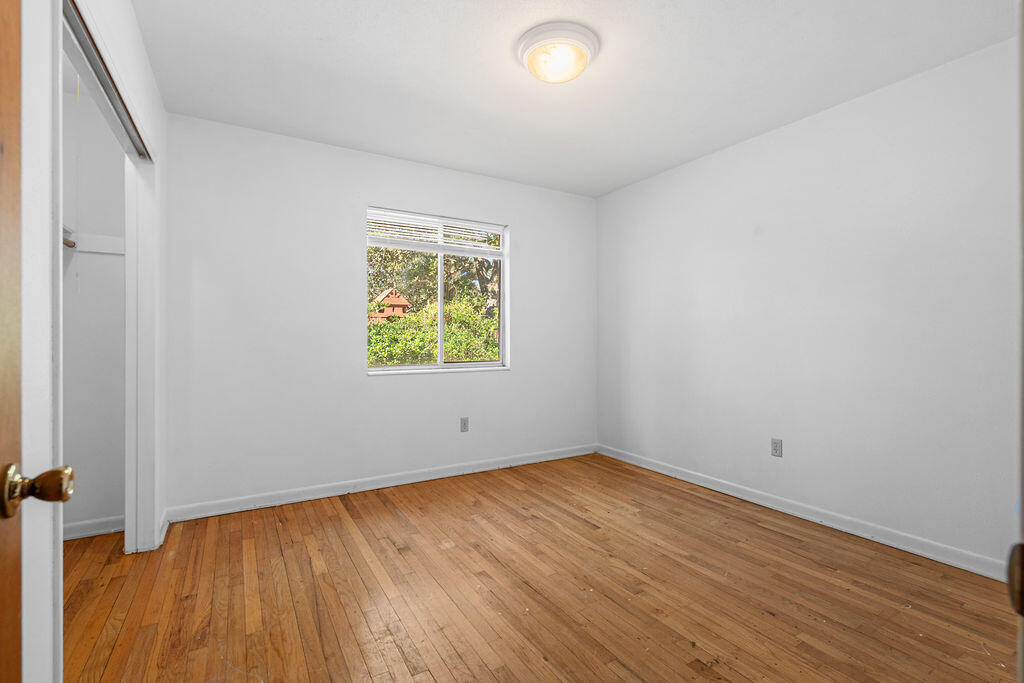 1623 18th Street Niceville, FL 32578 - Photo 25 of 41 an empty room with wooden floor and window