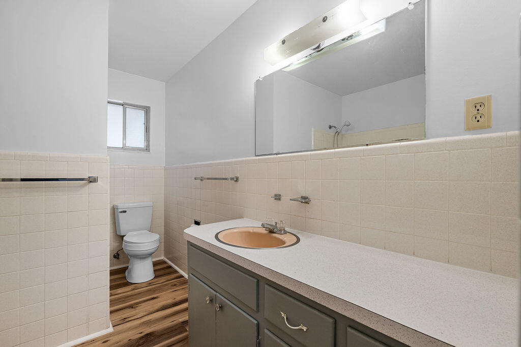 1623 18th Street Niceville, FL 32578 - Photo 26 of 41 a bathroom with a sink a toilet and a mirror