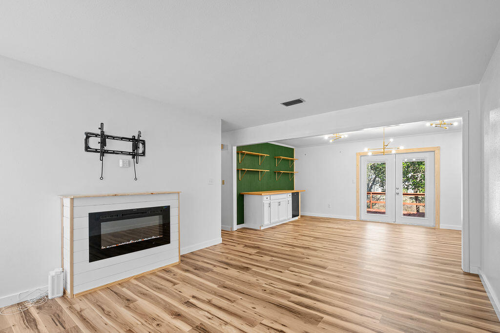 1623 18th Street Niceville, FL 32578 - Photo 5 of 41 a view of an empty room with a fireplace and a window