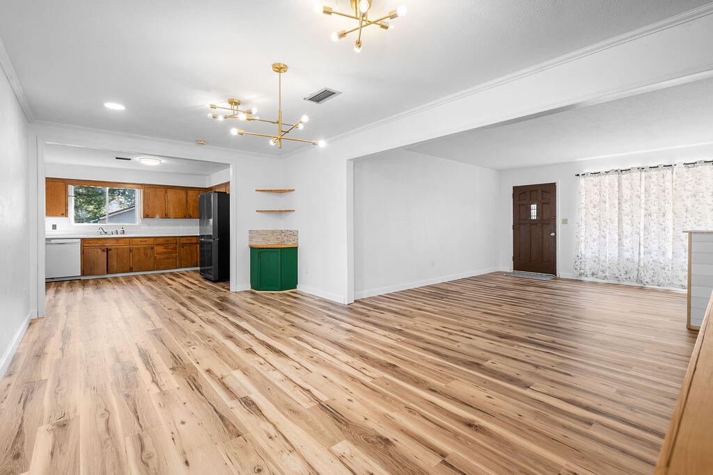 1623 18th Street Niceville, FL 32578 - Photo 7 of 41 a bedroom with a bed and a chandelier