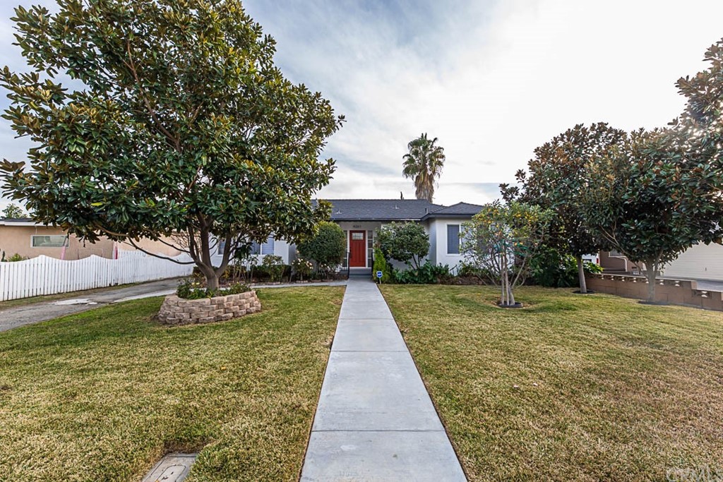 4261 Denver Street Montclair, CA 91763 - Photo 1 of 1 a front view of a house with a yard and trees