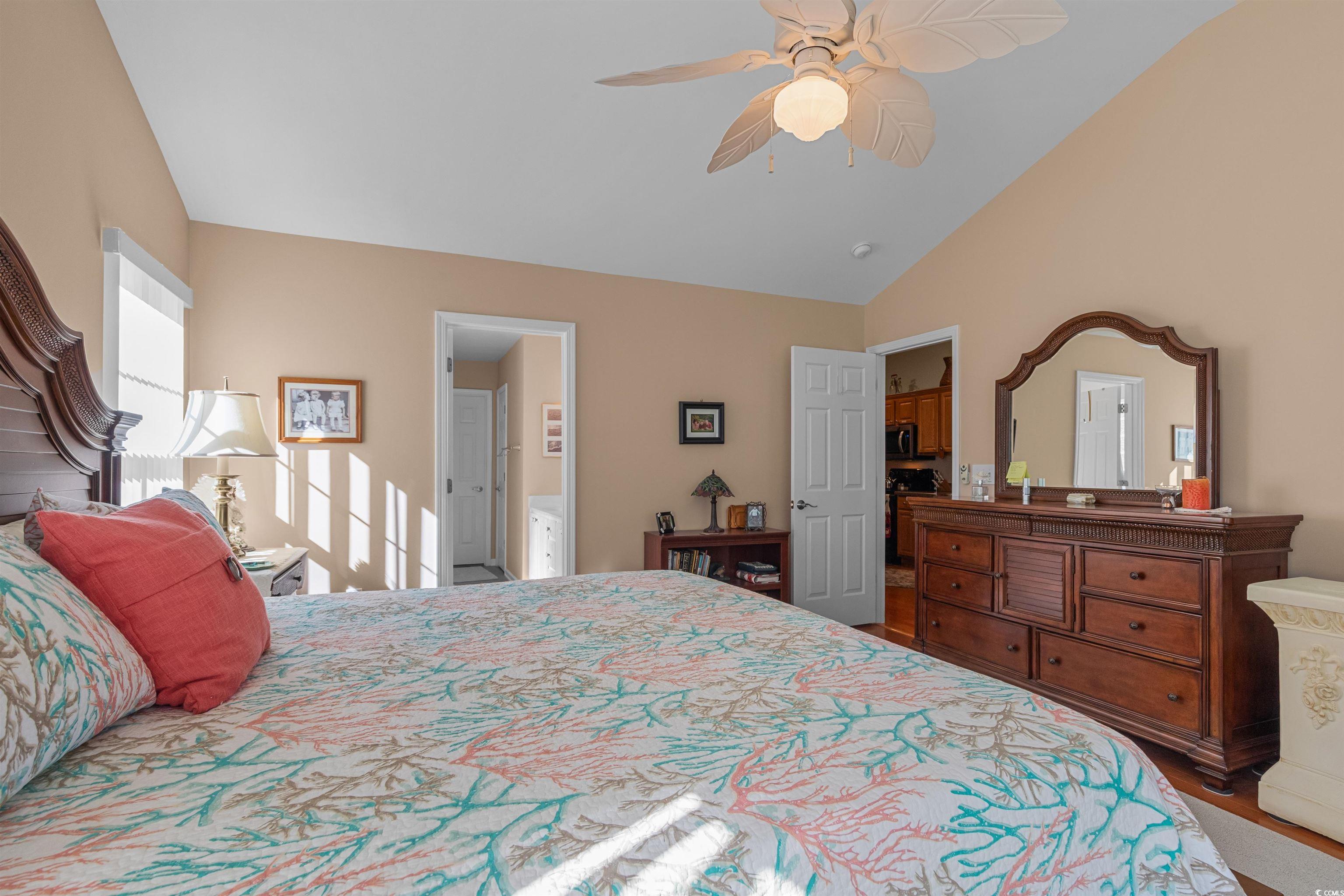 3505 Arrowhead Boulevard Myrtle Beach, SC 29579 - Photo 14 of 40 Bedroom featuring ceiling fan, lofted ceiling, ensuite bathroom, and wood finished floors