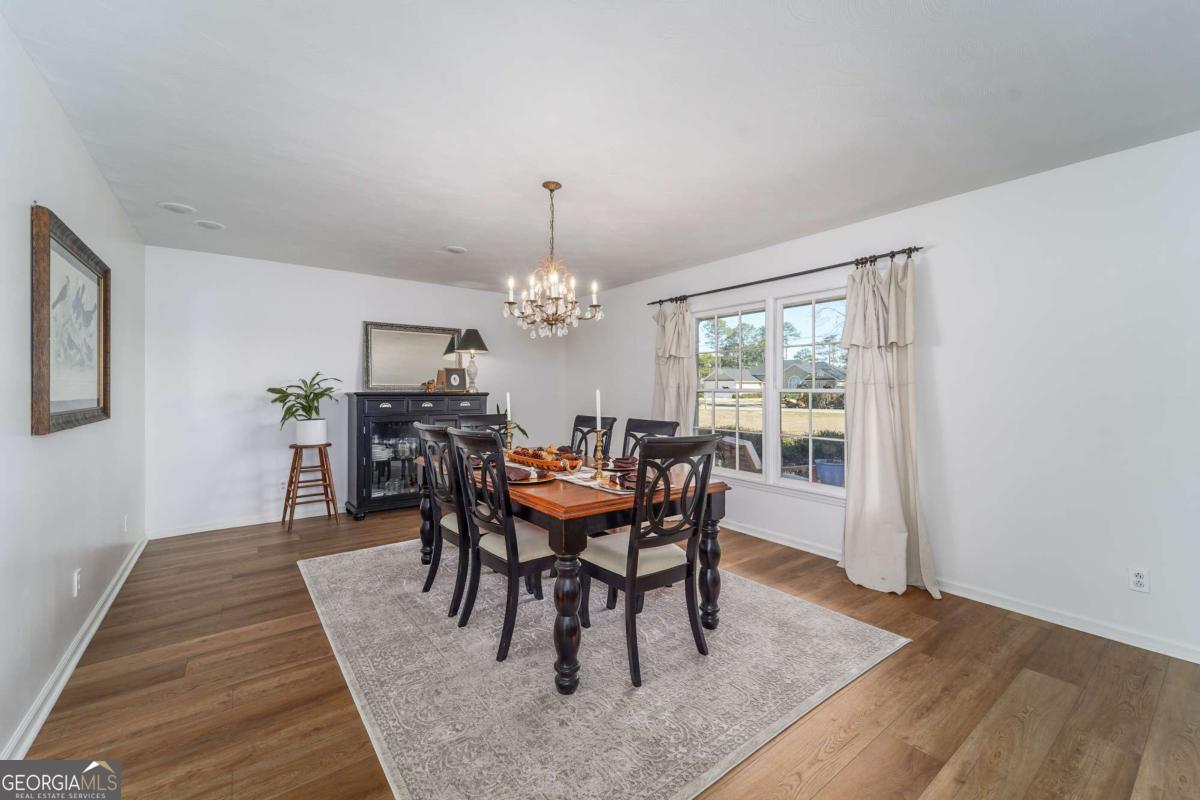 403 Rose Lane Douglas, GA 31533 - Photo 20 of 42 a view of a dining room with furniture window and wooden floor