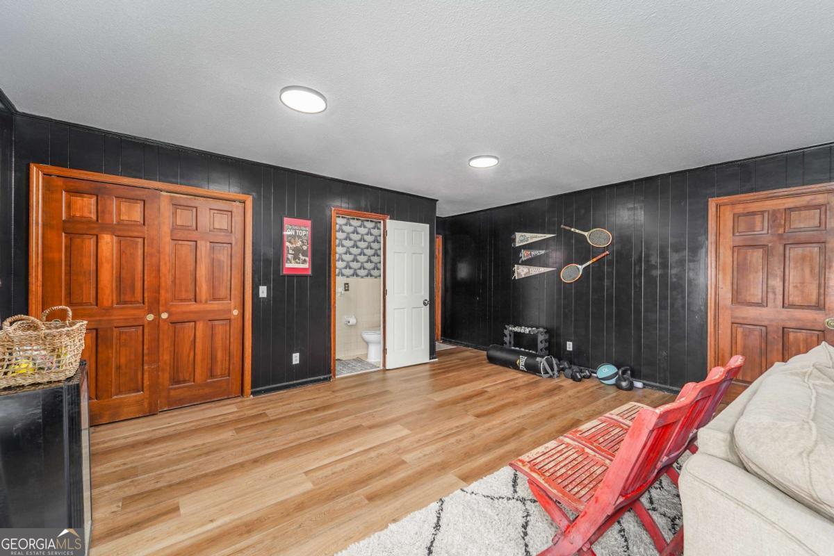 403 Rose Lane Douglas, GA 31533 - Photo 26 of 42 a room with gym equipment with wooden floor