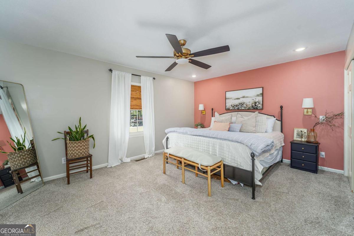 403 Rose Lane Douglas, GA 31533 - Photo 28 of 42 a bedroom with a bed and a potted plant