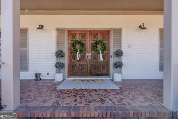 a view of a hallway with brick walls