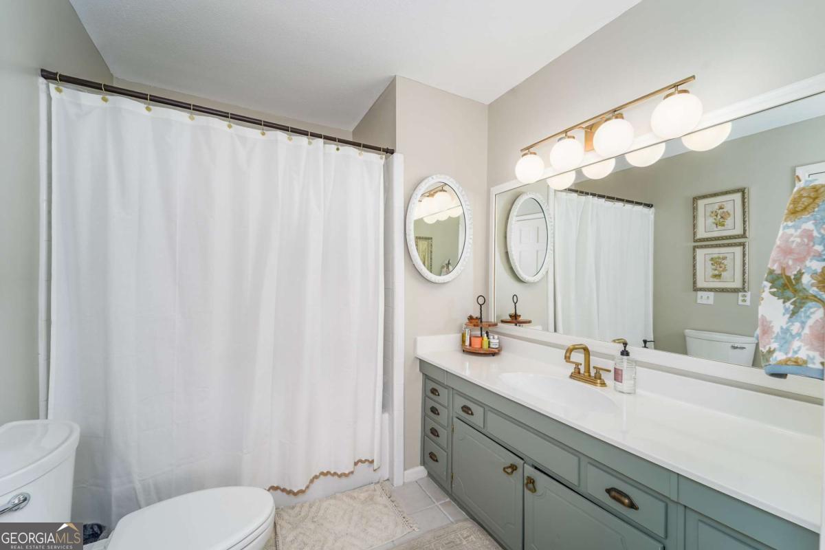 403 Rose Lane Douglas, GA 31533 - Photo 31 of 42 a bathroom with a double vanity sink mirror and toilet