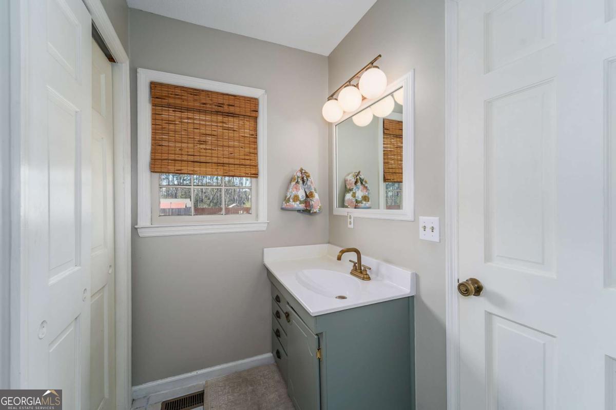 403 Rose Lane Douglas, GA 31533 - Photo 32 of 42 a bathroom with a sink and a window