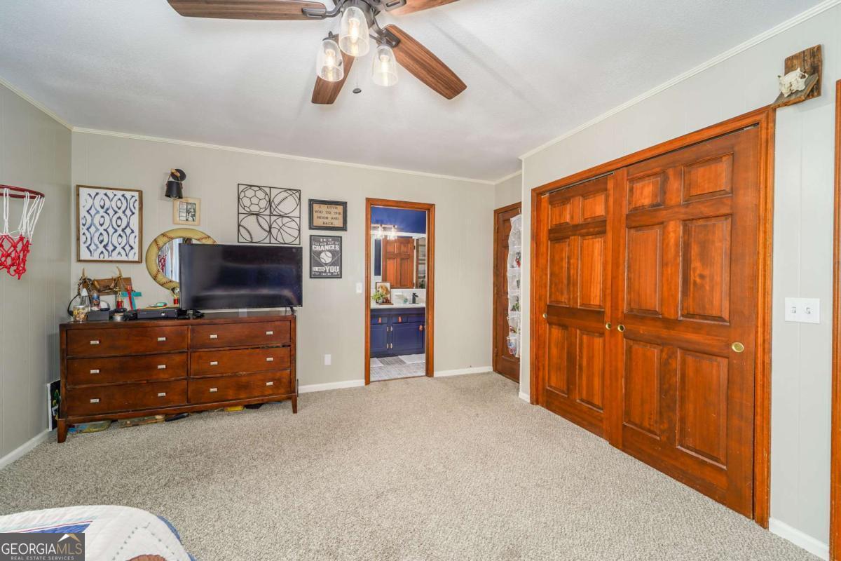 403 Rose Lane Douglas, GA 31533 - Photo 34 of 42 a living room with furniture and a flat screen tv