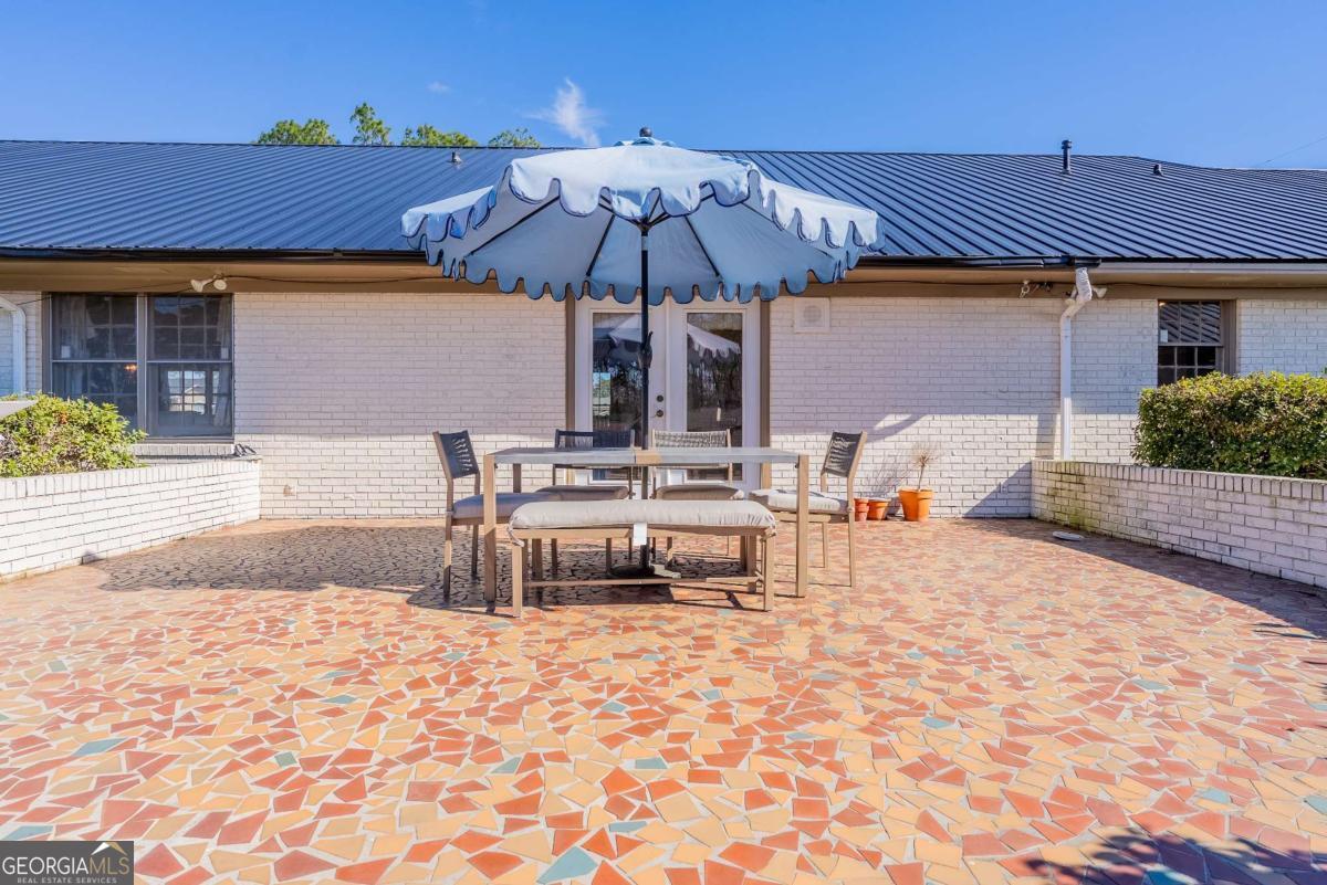 403 Rose Lane Douglas, GA 31533 - Photo 8 of 42 a backyard of a house with table and chairs