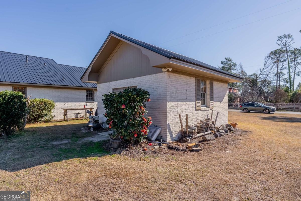 403 Rose Lane Douglas, GA 31533 - Photo 9 of 42 a view of a house with backyard and sitting area