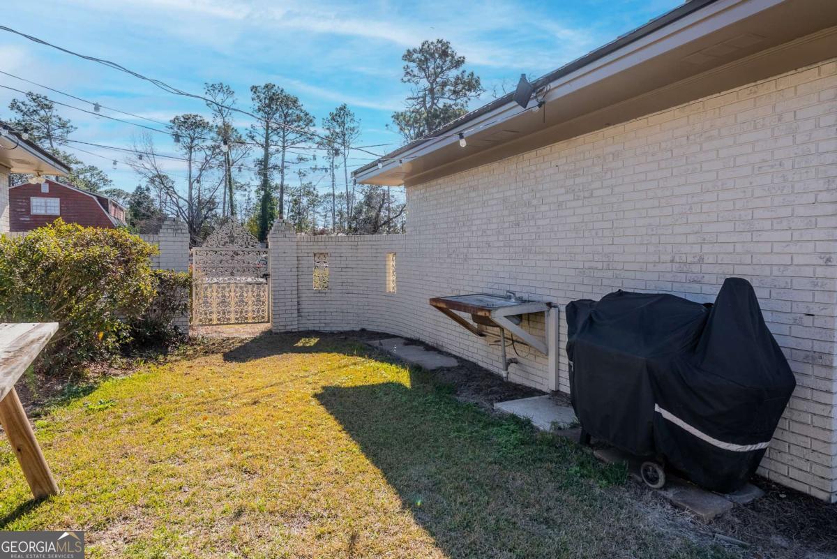 403 Rose Lane Douglas, GA 31533 - Photo 10 of 42 a view of a swimming pool with a lounge chairs