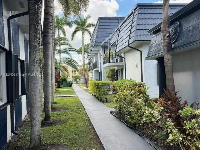 a front view of a house with plants
