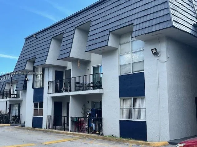 a view of a building with a tv on table and chairs