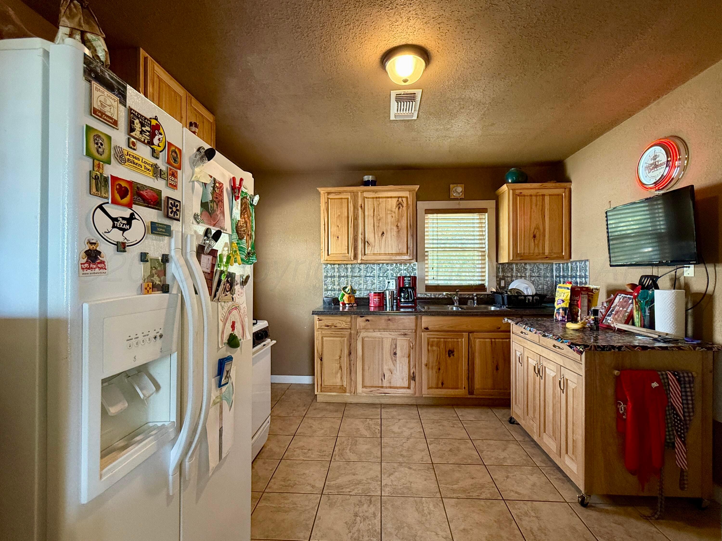 701 Brain Street Borger, TX 79007 - Photo 16 of 18 a kitchen with stainless steel appliances granite countertop a stove a sink and a refrigerator