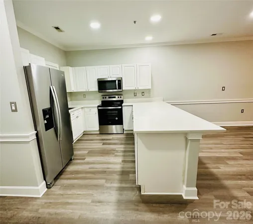 a kitchen with stainless steel appliances a refrigerator and a stove