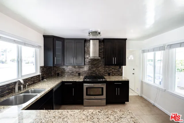 a kitchen with a sink stove and refrigerator