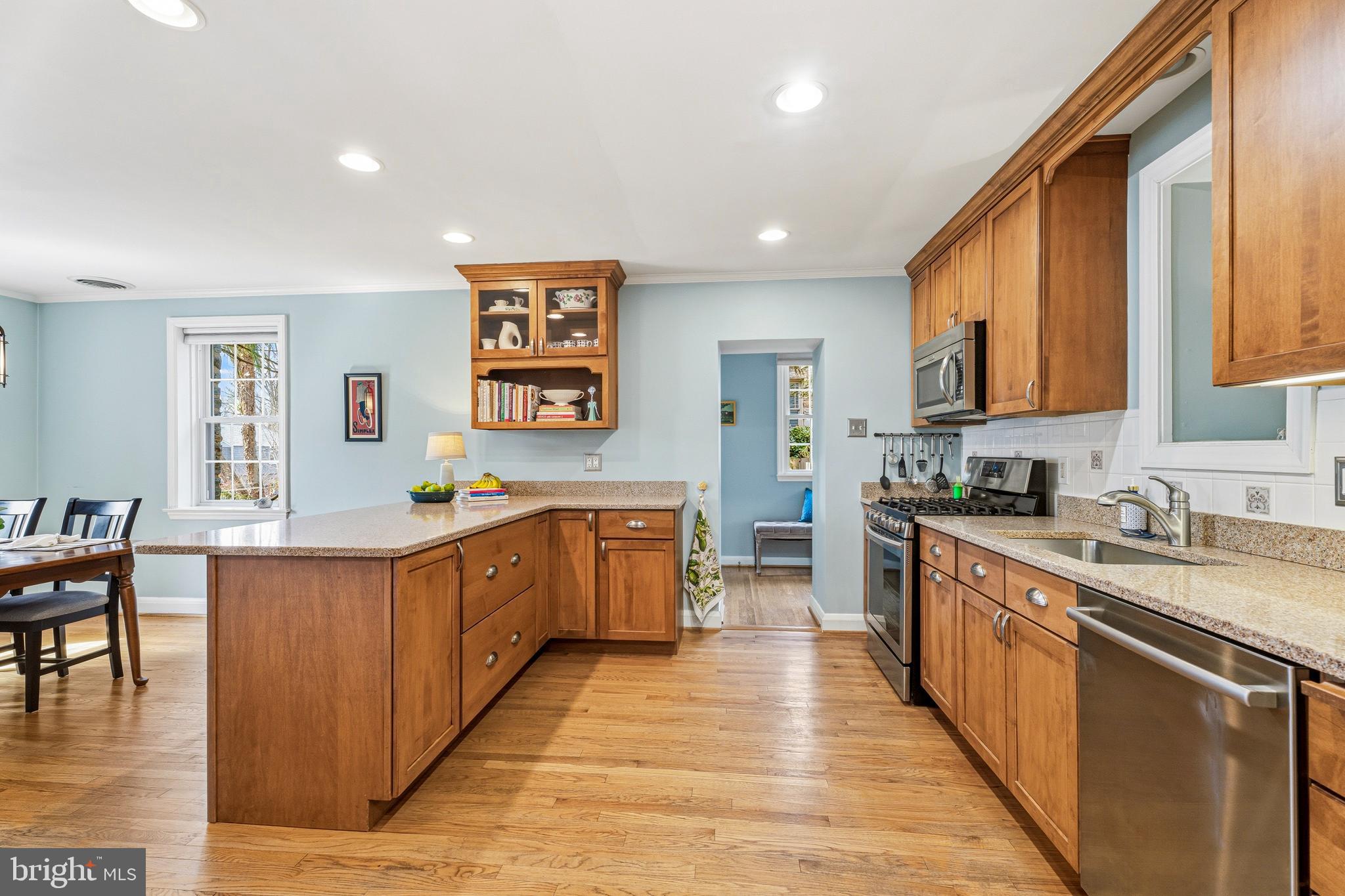 318 Alabama Road Towson, MD 21204 - Photo 21 of 72 a large kitchen with stainless steel appliances granite countertop wooden cabinets a sink and a wooden floors