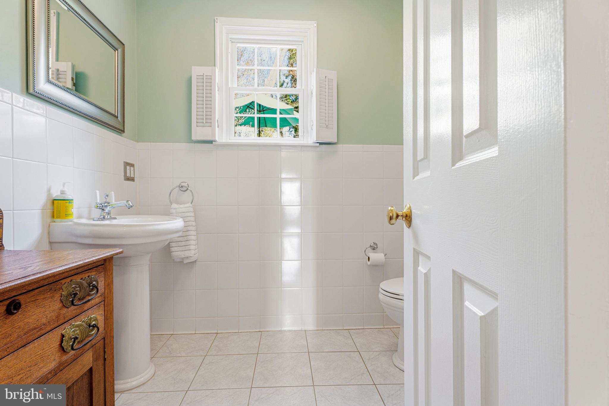 318 Alabama Road Towson, MD 21204 - Photo 30 of 72 a bathroom with a sink a toilet and a window