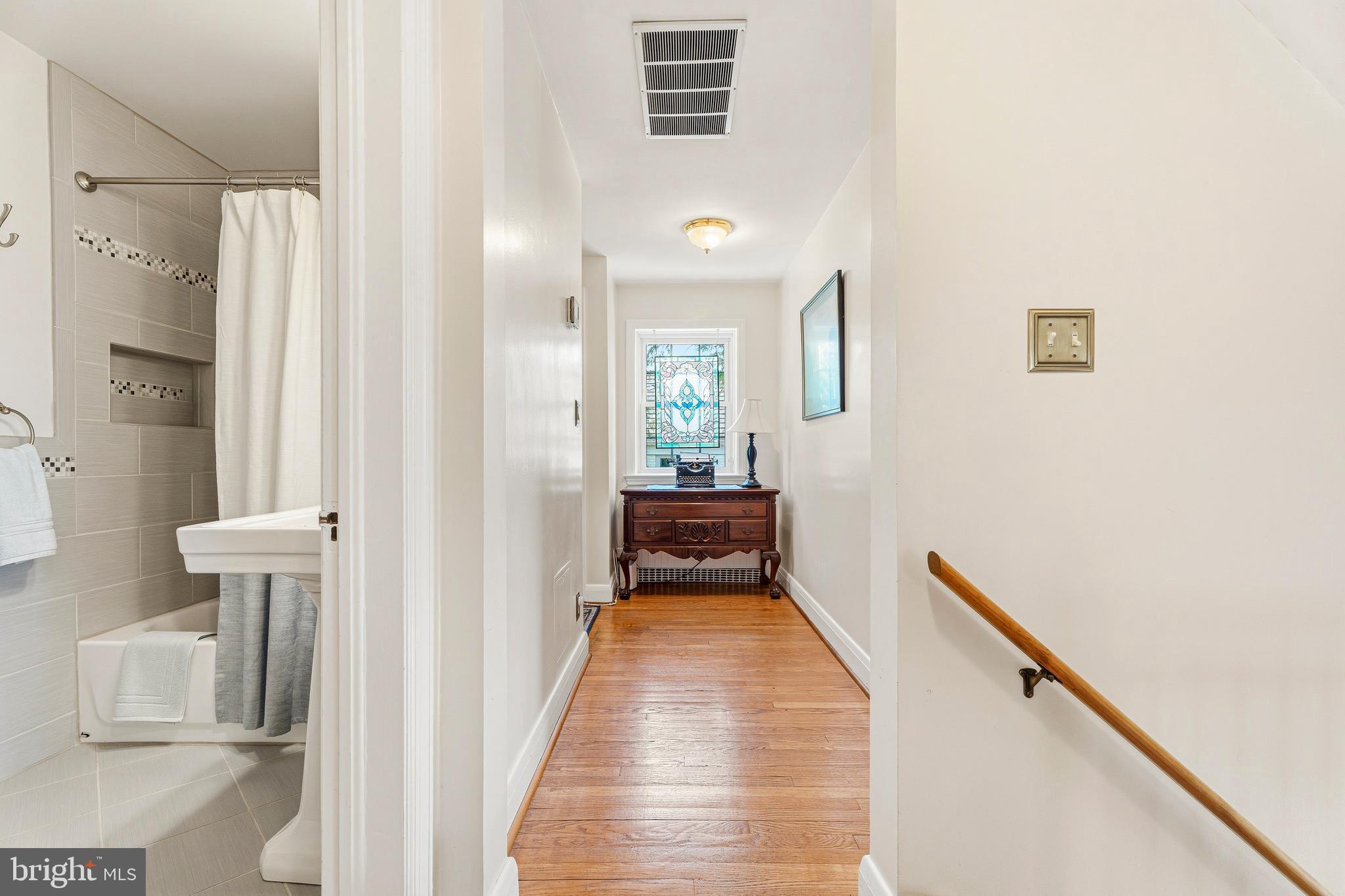 318 Alabama Road Towson, MD 21204 - Photo 40 of 72 a view of a hallway with wooden floor and staircase