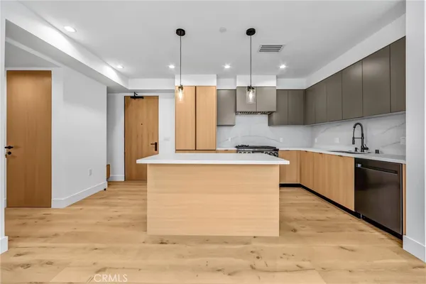 a kitchen with granite countertop a sink stove and cabinets