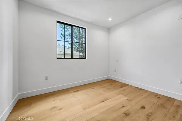 a spacious bedroom with a bed and a window