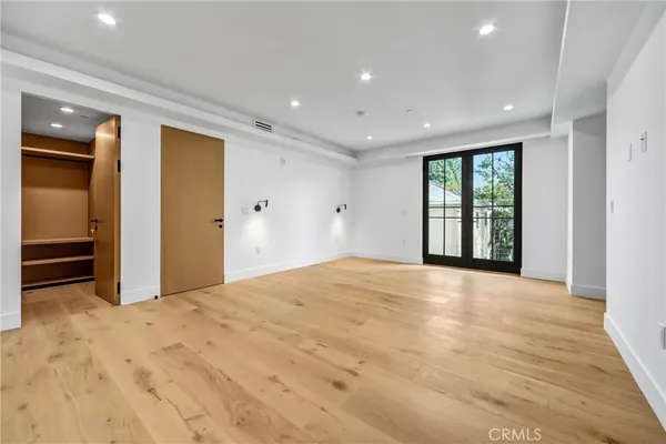 a bedroom with a large bed and a large window