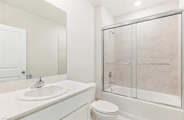 a bathroom with a white toilet sitting next to a bathroom sink