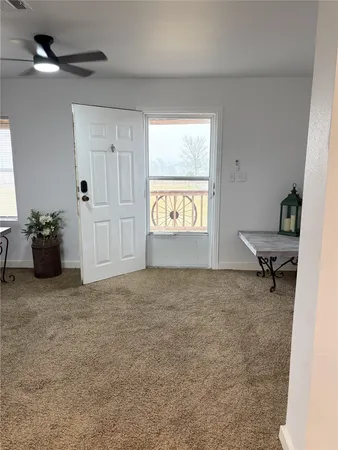 a view of an empty room and a window