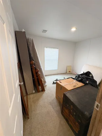 a bedroom with a bed and a large mirror