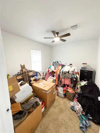a bed room with two beds and a ceiling fan