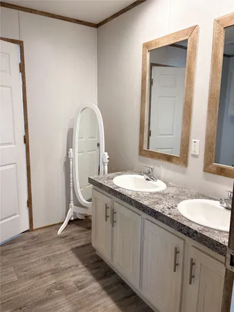 a bathroom with a granite countertop sink a toilet and a mirror