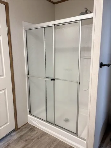 a bathroom with a glass shower door
