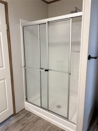 a bathroom with a glass shower door