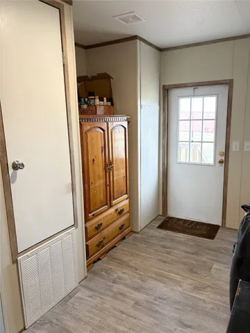 a view of front door with wooden floor