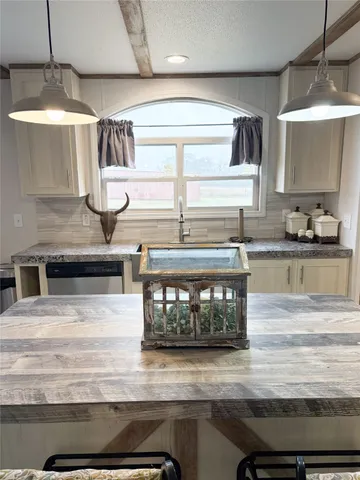 a kitchen with stainless steel appliances granite countertop a stove and a microwave