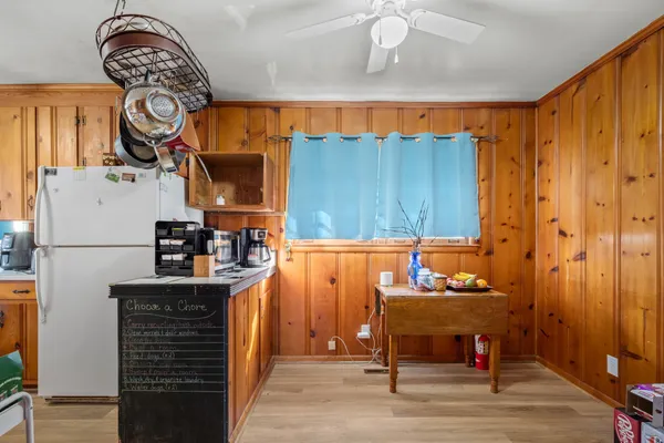 a view of a dining room with furniture and chandelier