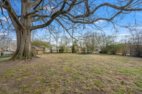 a view of dirt yard with a fountain