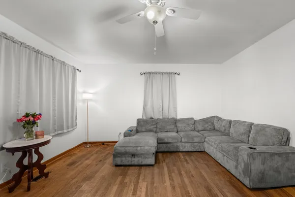 a living room with furniture and a chandelier