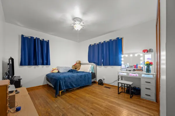 a bedroom with furniture and a wooden floor