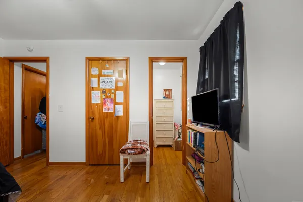 a view of room with wooden floor and windows
