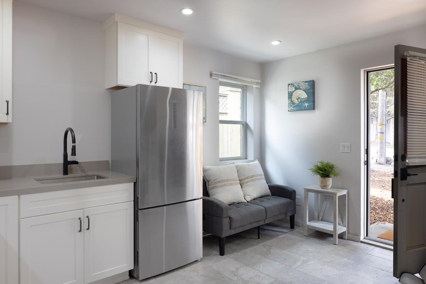 0 Carpenter & 2nd Nw Corner Carmel, CA 93921 - Photo 21 of 23 a kitchen with stainless steel appliances white cabinets and a window