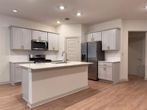 10609 Defender Trail Austin, TX 78754 - Photo 3 of 11 A well-appointed kitchen showcases an inviting island, ample cabinetry, and sleek appliances, ideal for culinary creations.