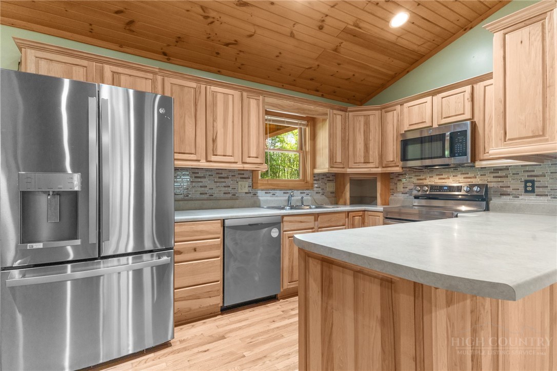 148 Woodby Ridge Road Vilas, NC 28692 - Photo 9 of 33 a kitchen with stainless steel appliances granite countertop a refrigerator sink and microwave