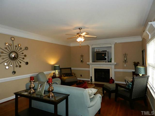 343 Ina Joe Place Willow Spring, NC 27592 - Photo 3 of 23 a living room with furniture a fireplace and a flat screen tv