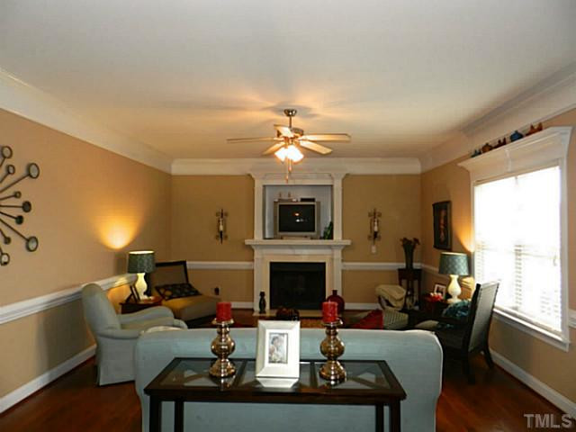 343 Ina Joe Place Willow Spring, NC 27592 - Photo 4 of 23 a living room with furniture a fireplace and a flat screen tv